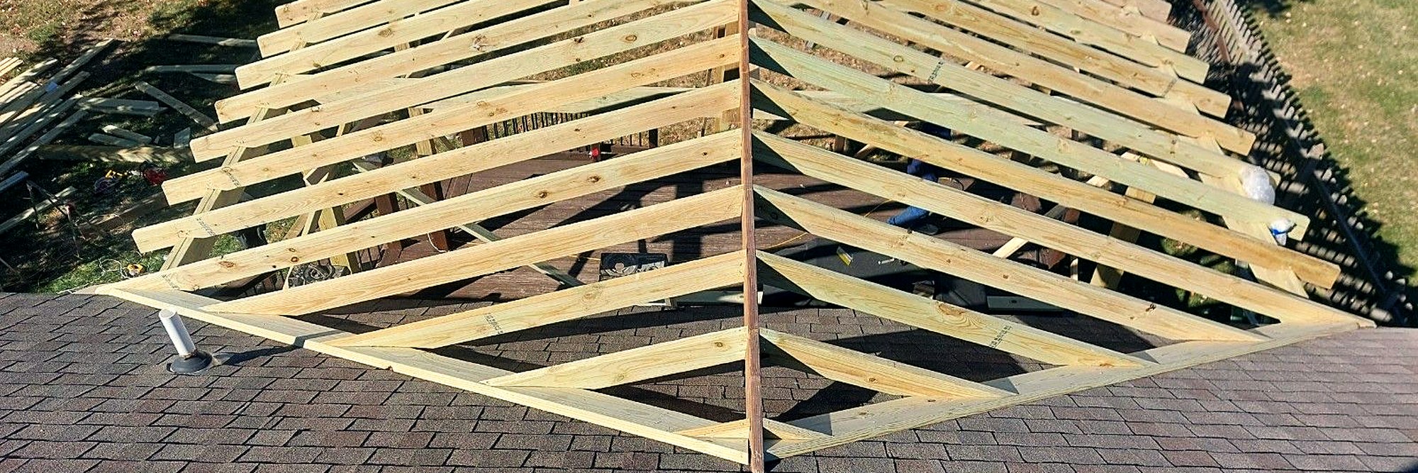 Porch roof framing seen from above, looking down the rafters.