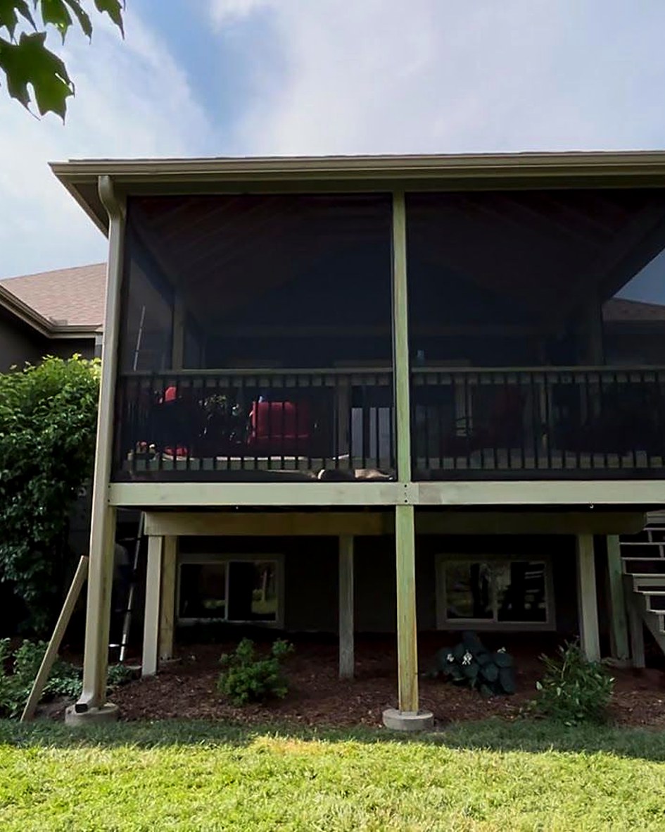 Finished screened porch with its door closed, seen from the yard.