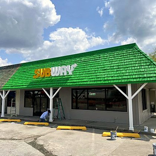 New timber entry canopy on a commercial storefront.