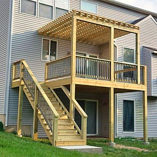 Elevated deck with a pergola and a full stair run to the yard.
