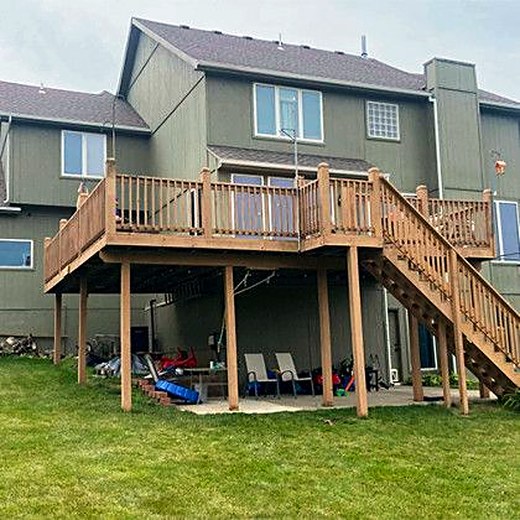 Two-story deck with a stair run down to the lawn.