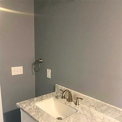 New vanity with a stone counter in a finished lower level.