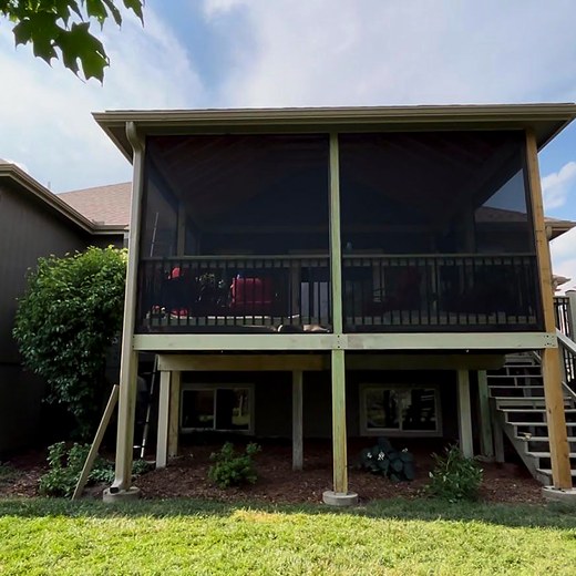 Finished screened-in porch on the rear of a two-story house.