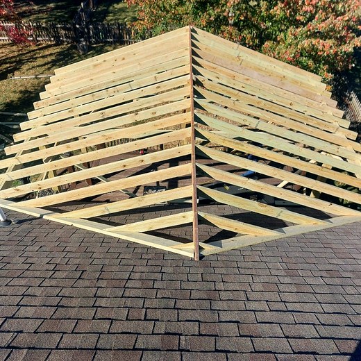 Porch roof framing seen from above, looking down the rafters.