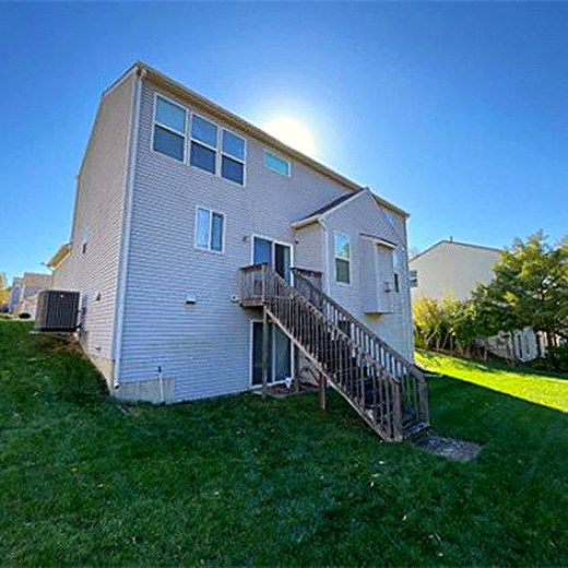 The back of a two-story home before its new deck went in.