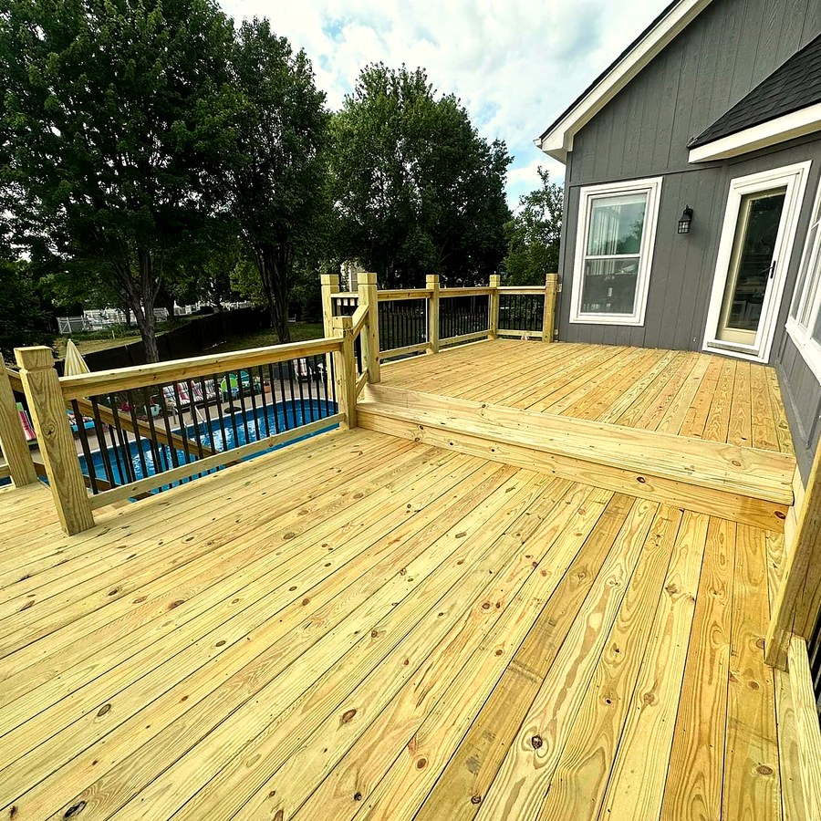 Timber deck wrapping an above-ground pool.