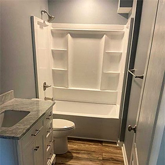 Finished lower-level bathroom with tiled shower surround.
